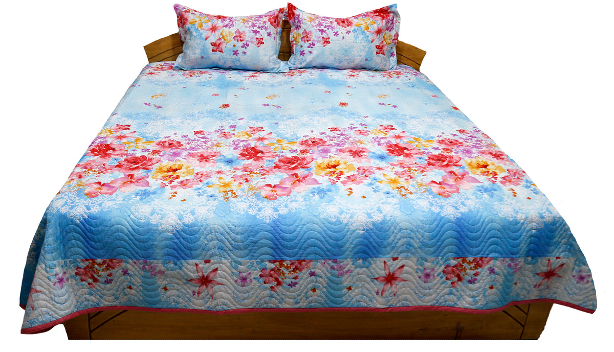 Sky blue floral printed quilted bedcover with matching pillow covers, straight view
