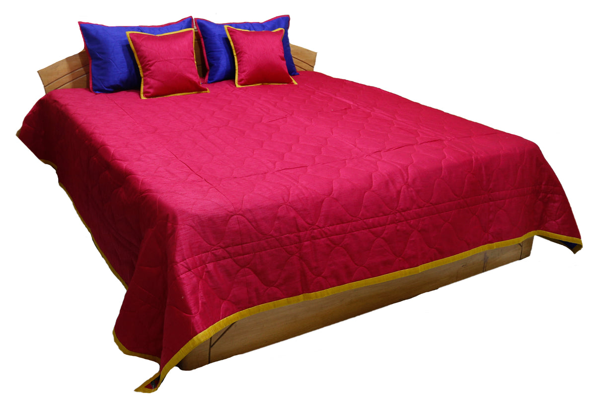 Crimson reverse side of the bedcover with royal blue and gold cushion covers