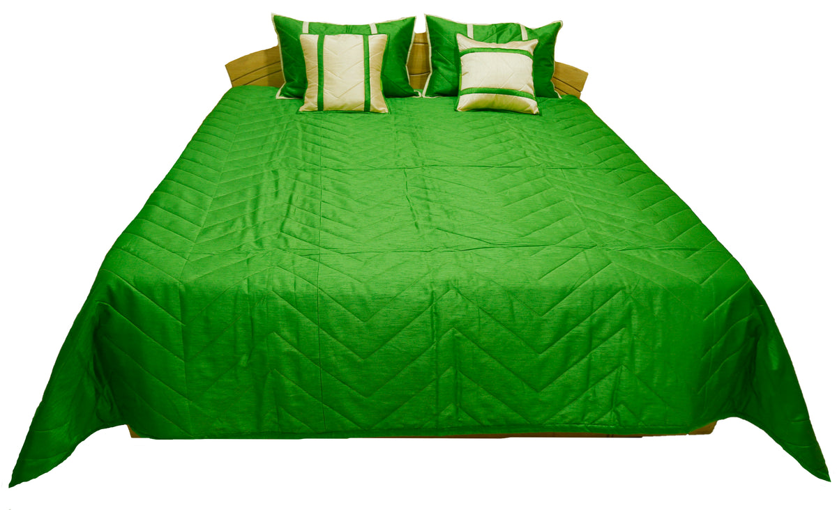 Emerald green quilted bedcover with two cream and green cushion covers