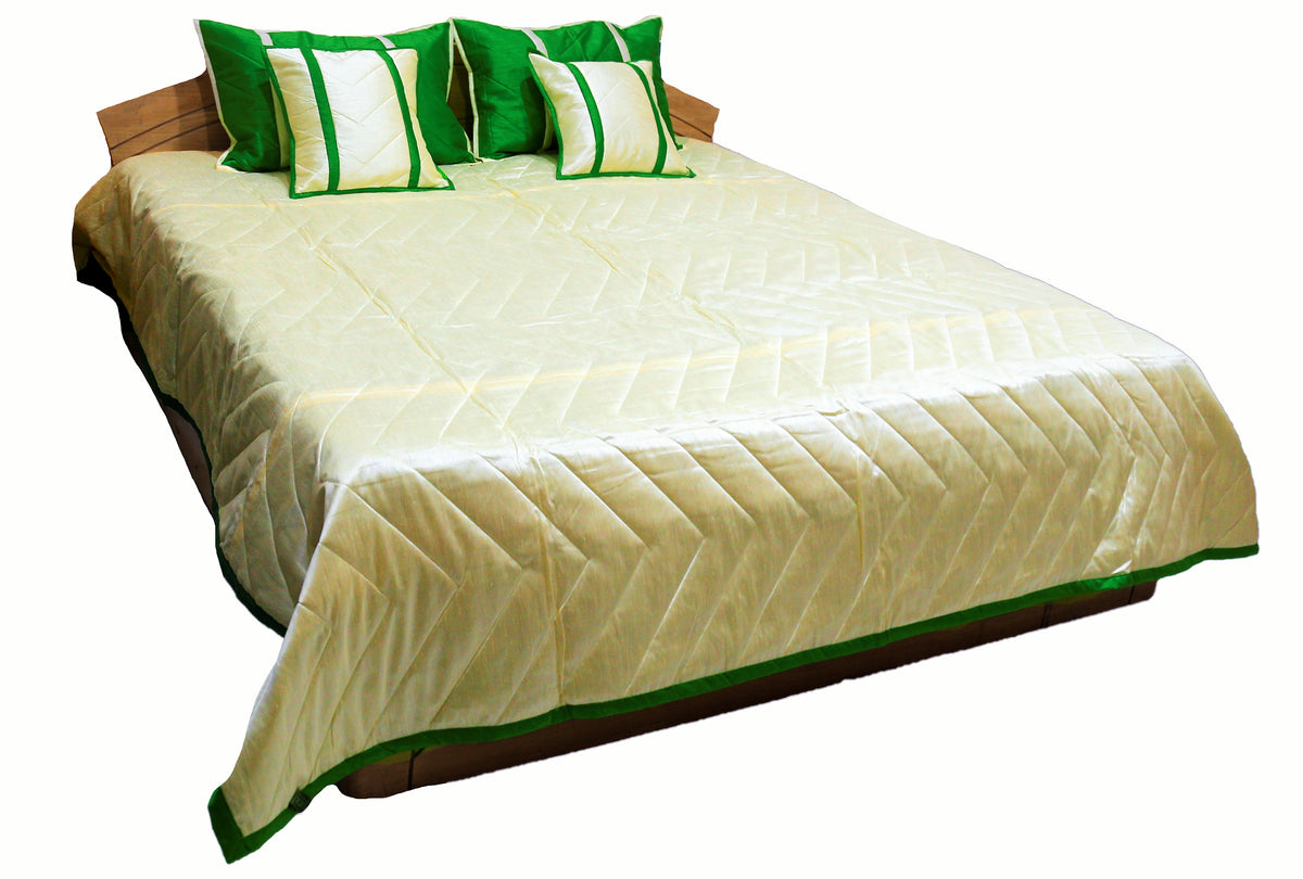 Cream reverse side of the bedcover with green bordered edge and green cushions
