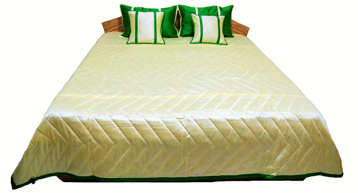 Cream quilted side laid flat with green border and cream and green cushions