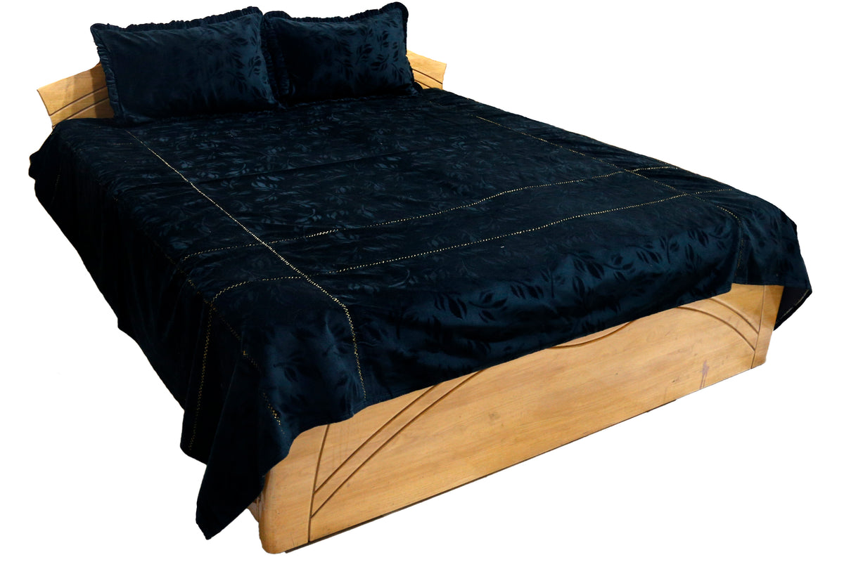 Black bedcover with an embossed woven leaf pattern, styled with 2 matching pillow covers