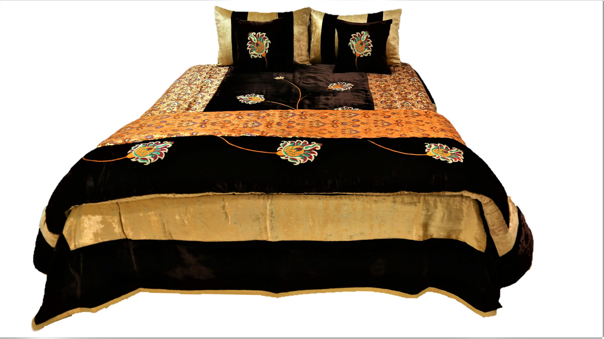 Black and gold flower embroidered velvet wedding set made up on a double bed