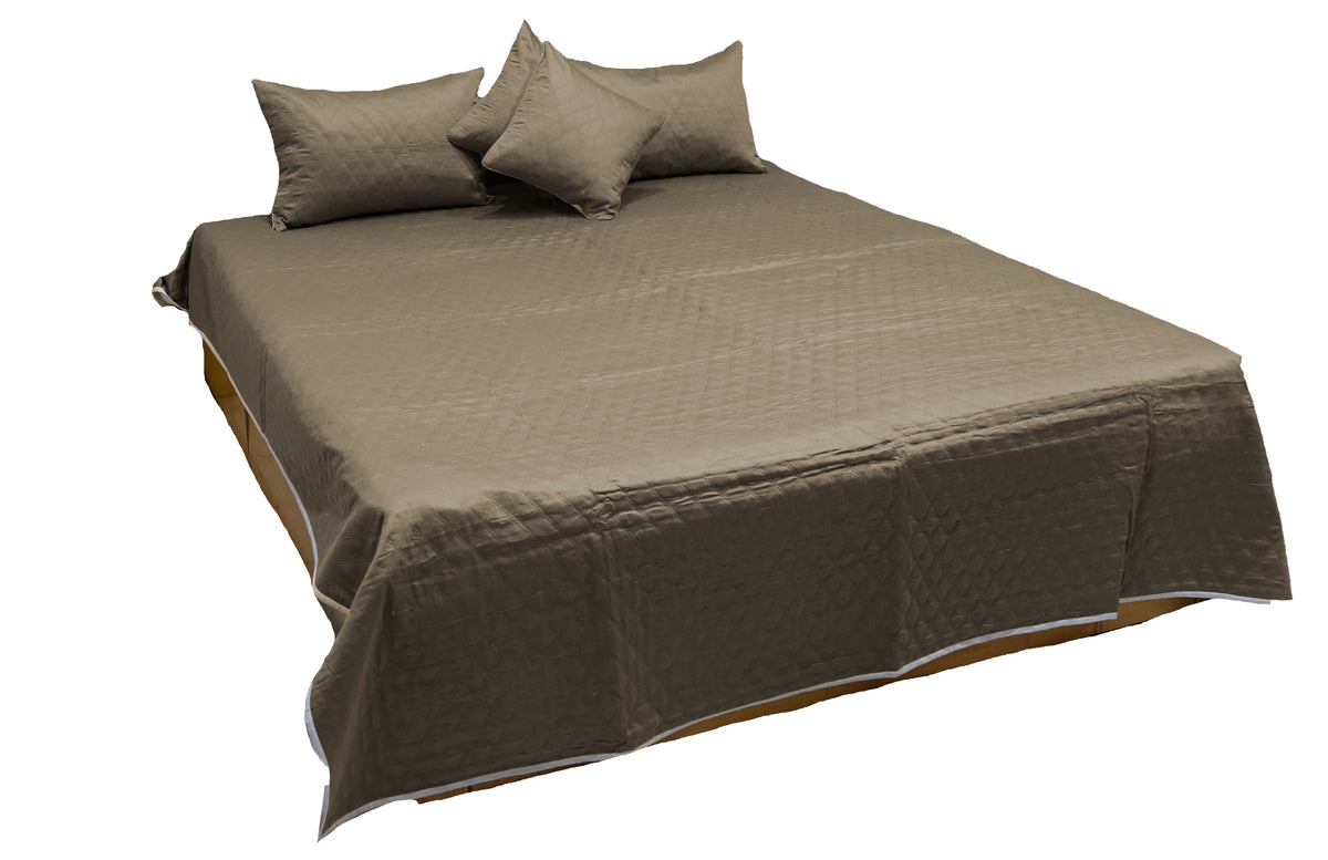 Olive taupe cotton bedcover with diamond quilting and matching covers, angled view